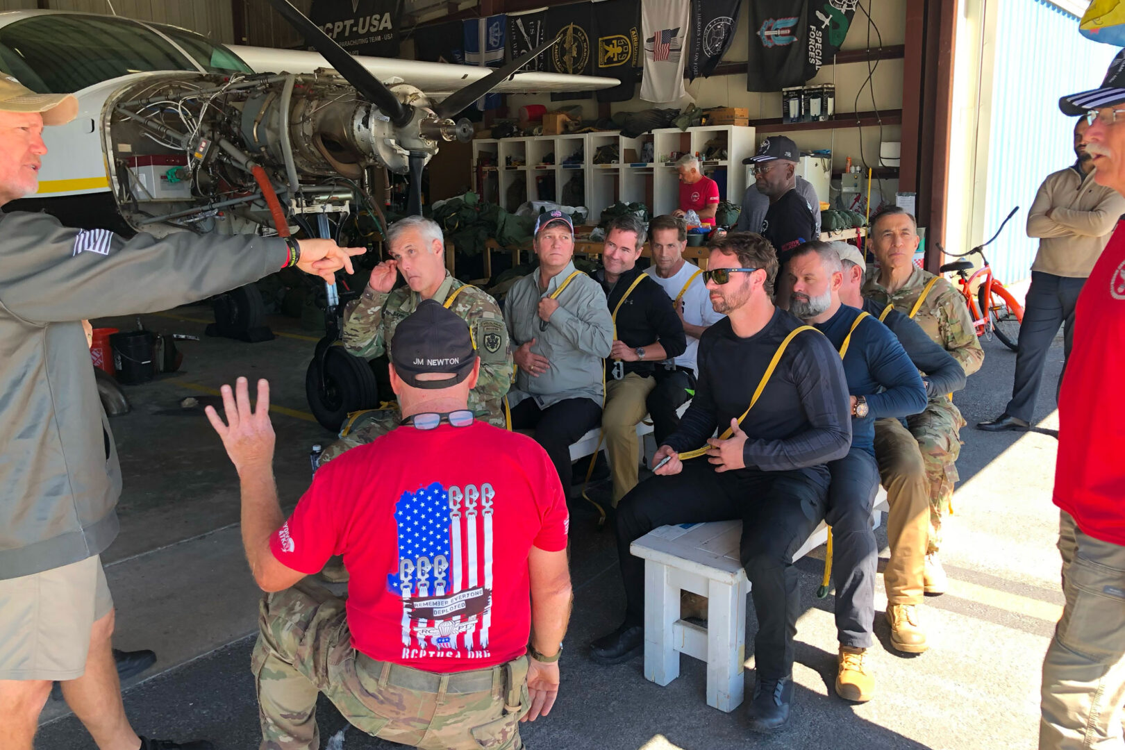 Rep. Michael Waltz, seated in center, and other military veterans in Congress attend an April training session with the Round Canopy Parachuting Team. Waltz will jump from a C-47 later this week to mark the 80th anniversary of D-Day.