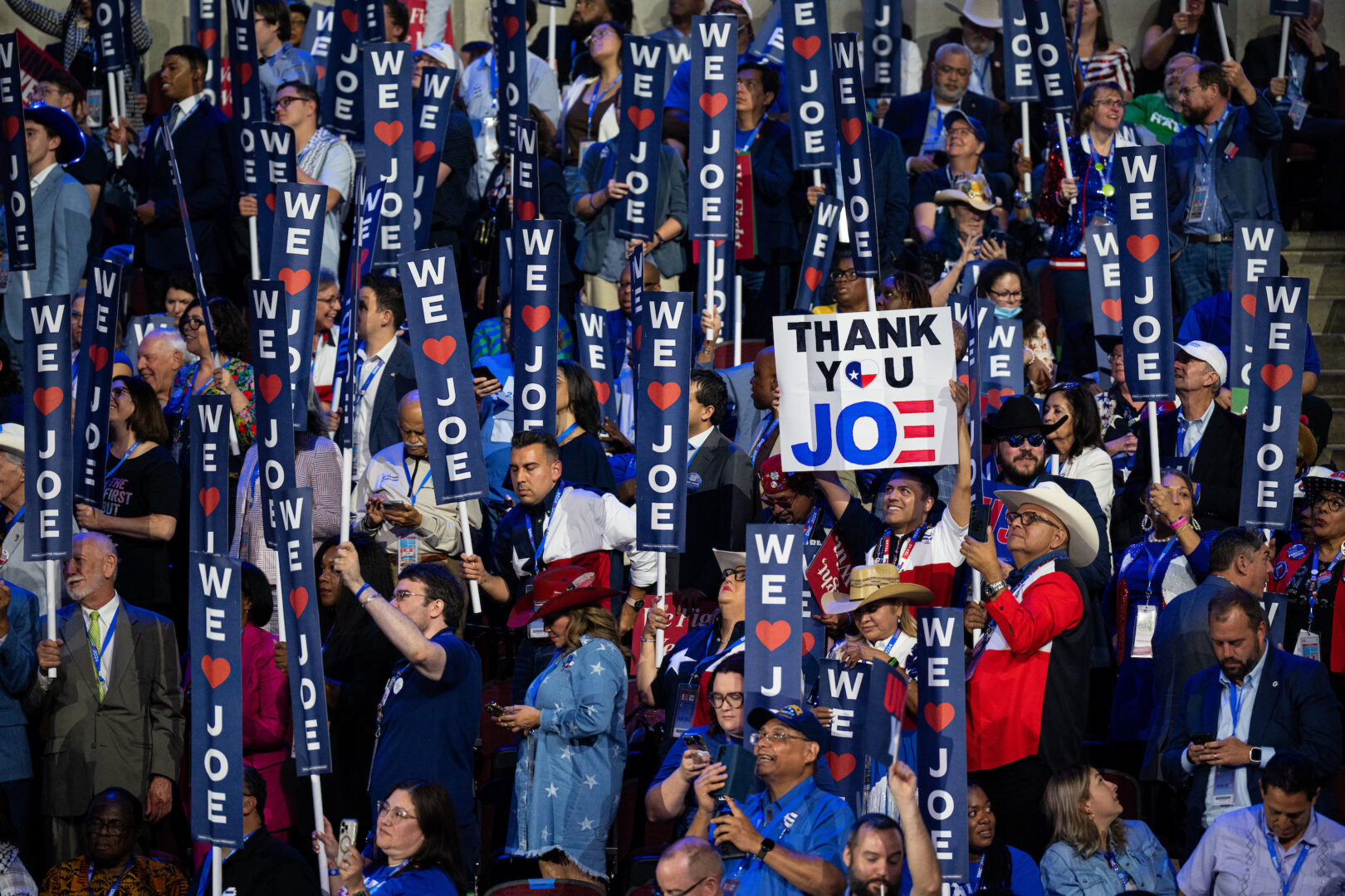 Delegates wave signs as President Joe Biden speaks during the 2024 Democratic National Convention on Monday. (Bill Clark/CQ Roll Call)