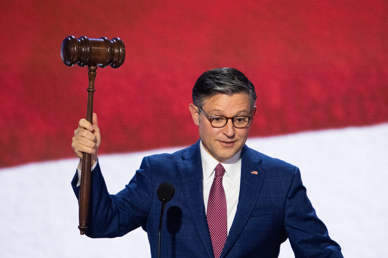 Speaker Mike Johnson holds the convention gavel during his podium check on stage at the Fiserv Forum in Milwaukee before the start of the Republican National Convention on July 15.