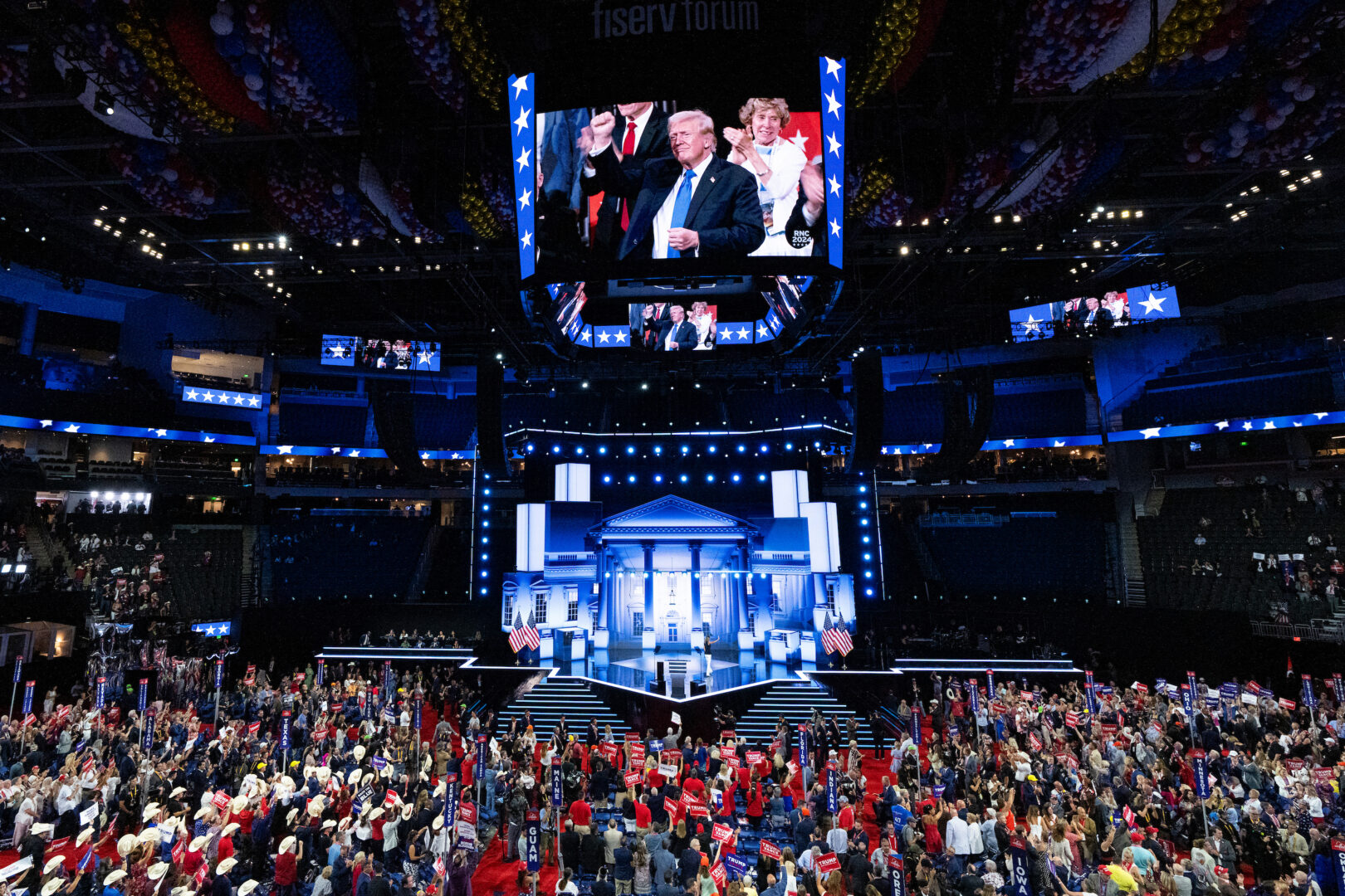 Former President Donald Trump is seen raising his fist on the jumbotron in the Fiserv Forum at the Republican National Convention in Milwaukee on Tuesday. With an agenda highlighting supposed mayhem in Democratic cities, Republican calls for unity were already ringing hollow, Curtis writes.