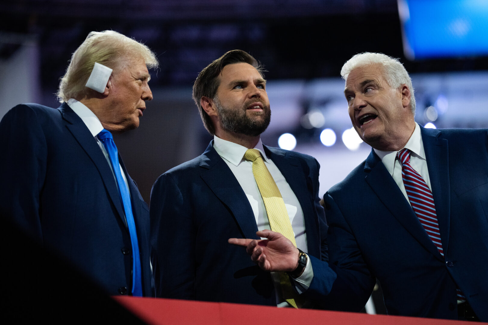 Former President Donald Trump, the Republican presidential nominee, and running mate Sen. JD Vance, R-Ohio, talk with House Majority Whip Tom Emmer, R-Minn., in Fiserv Forum on the second day of Republican National Convention in Milwaukee on Tuesday. 