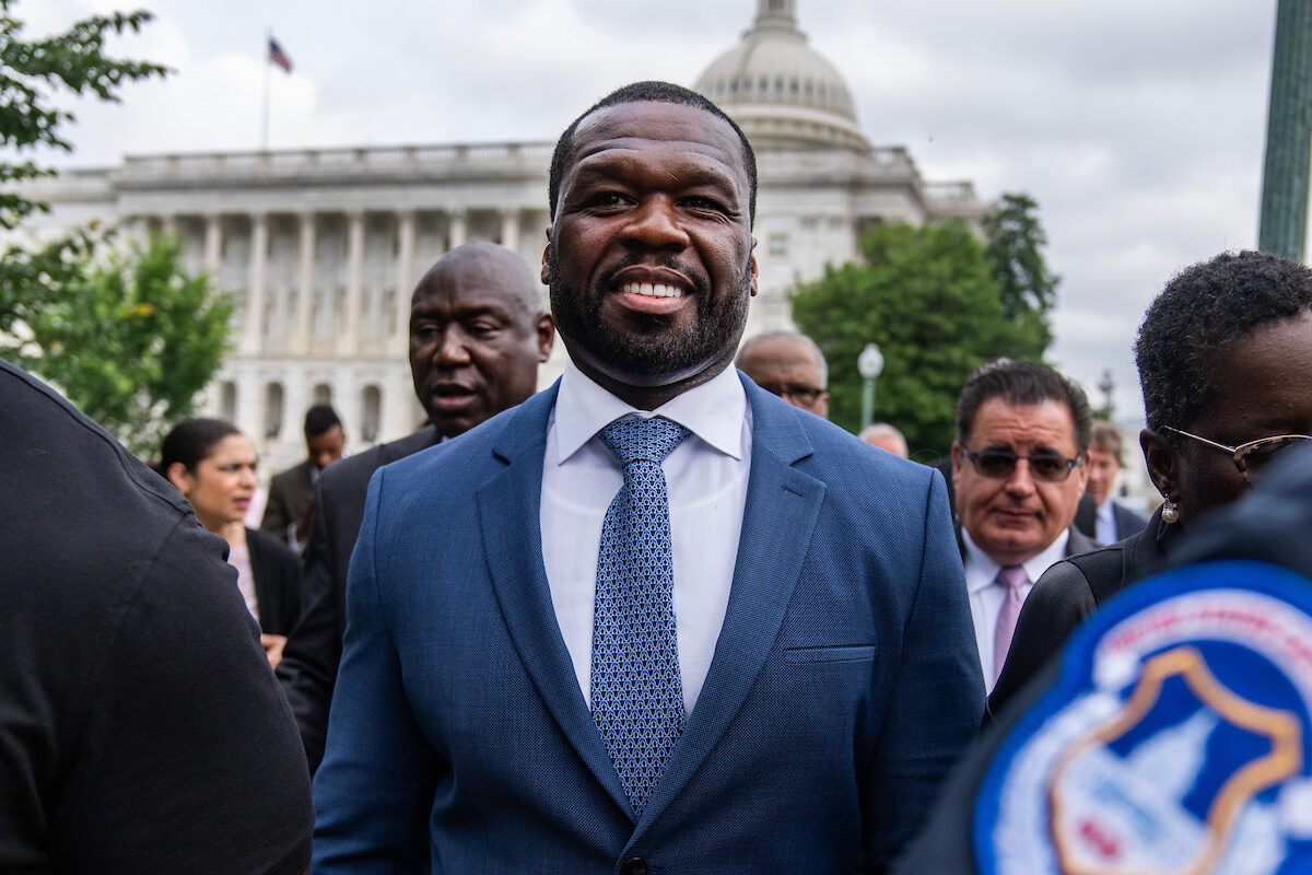 Curtis “50 Cent” Jackson and attorney Ben Crump, left, leave a news conference at the Capitol on Wednesday after meeting with congressional leaders about increasing minority representation in the multibillion-dollar luxury spirits industry.