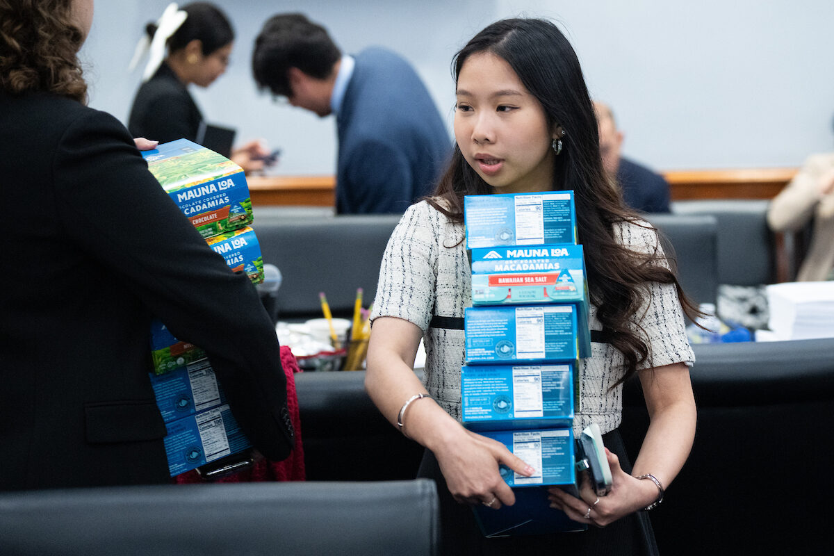 Staffers pass out Mauna Loa macadamia nuts from Hawaii Democratic Rep. Ed Case to House Appropriations Committee members before the start of the  markup of several spending bills in the Rayburn House Office Building on July 10.