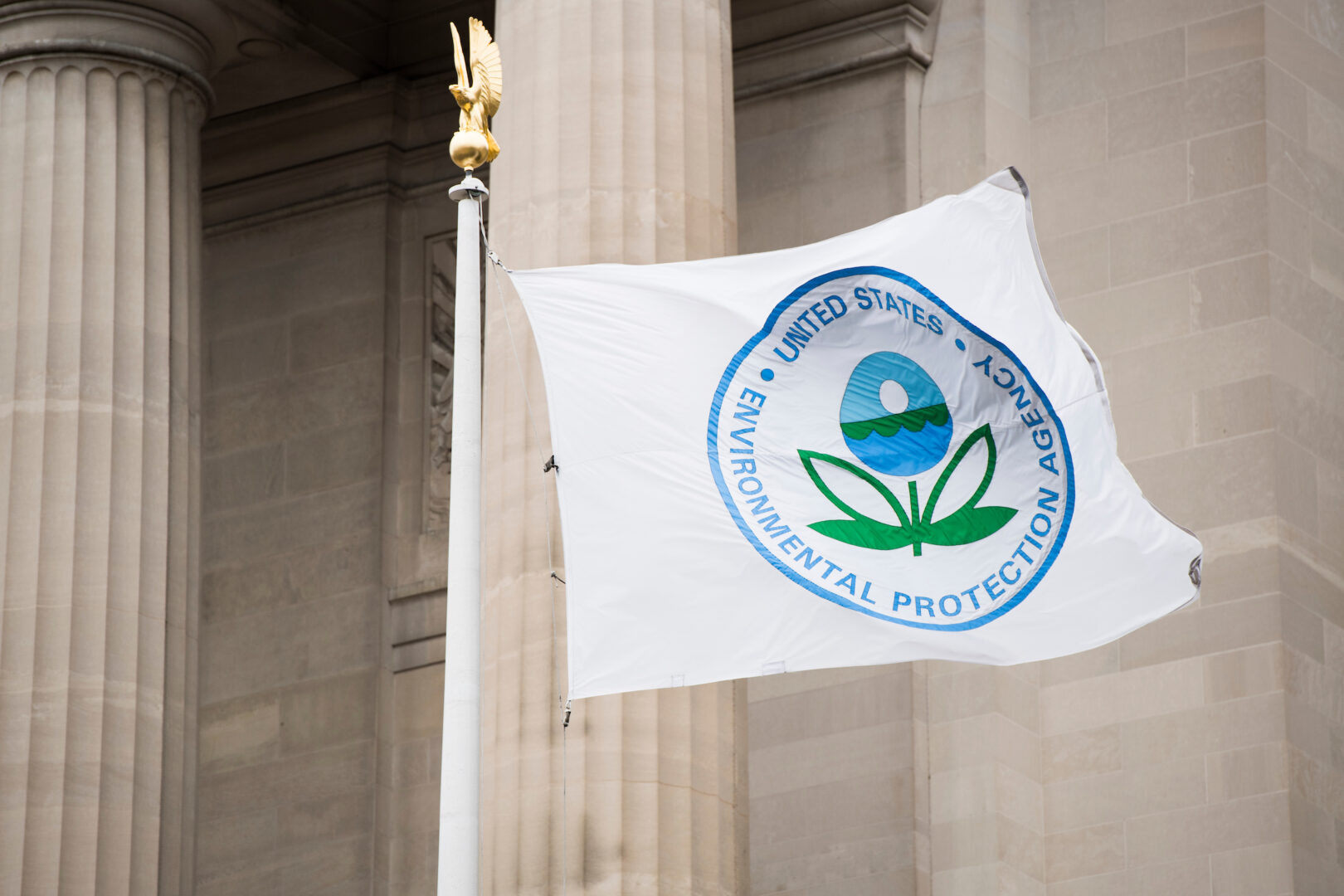 A flag with the EPA logo flies in front of the agency.