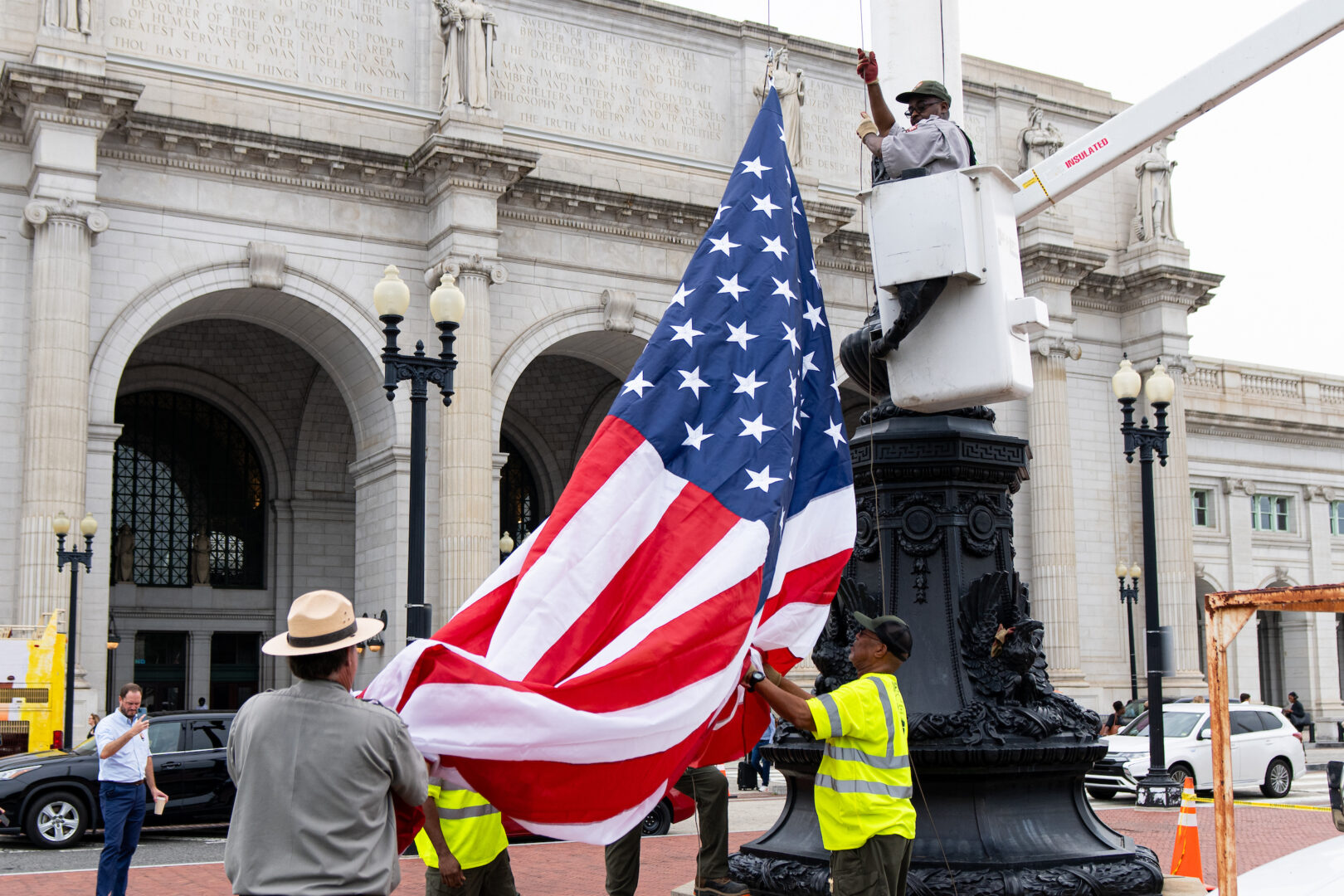 National Park Service workers replace one of the American flags outside Union Station on Thursday that had been removed during  protests of Israeli Prime Minister Benjamin Netanyahu’s address to a joint meeting of Congress.