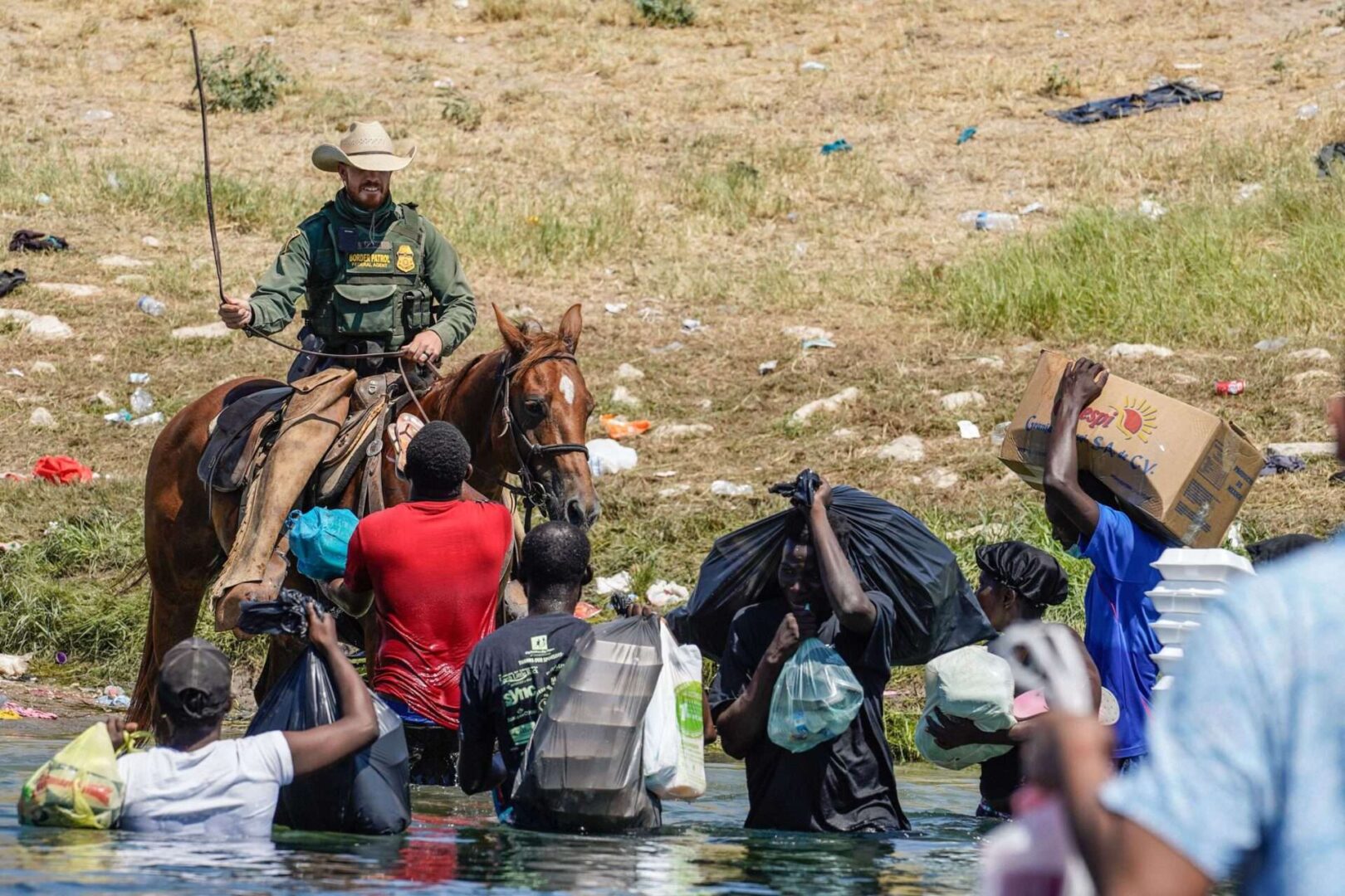 A United States Border Patrol agent on horseback uses the reins as he tries to stop Haitian migrants from entering an encampment on the banks of the Rio Grande near the Acuna Del Rio International Bridge in Del Rio, Texas on September 19, 2021. 