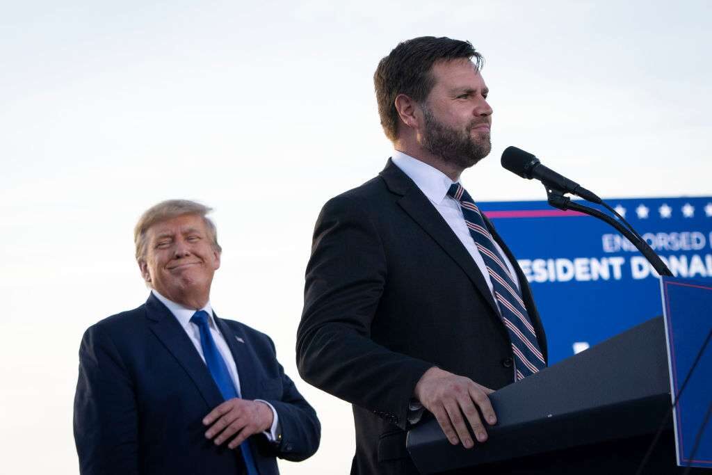 Former President Donald Trump listens as Republican Senate candidate J.D. Vance speaks during a rally on April 23 in Delaware, Ohio.