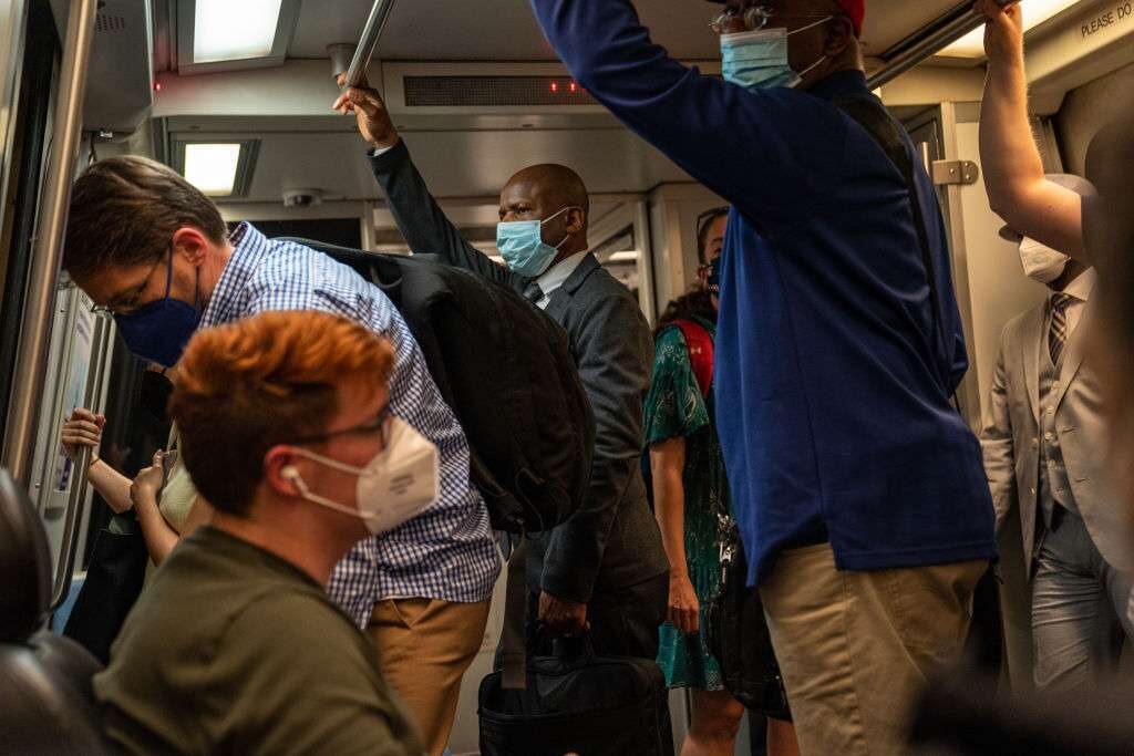 Commuters wearing masks travel on the Washington Metro on April 14. 