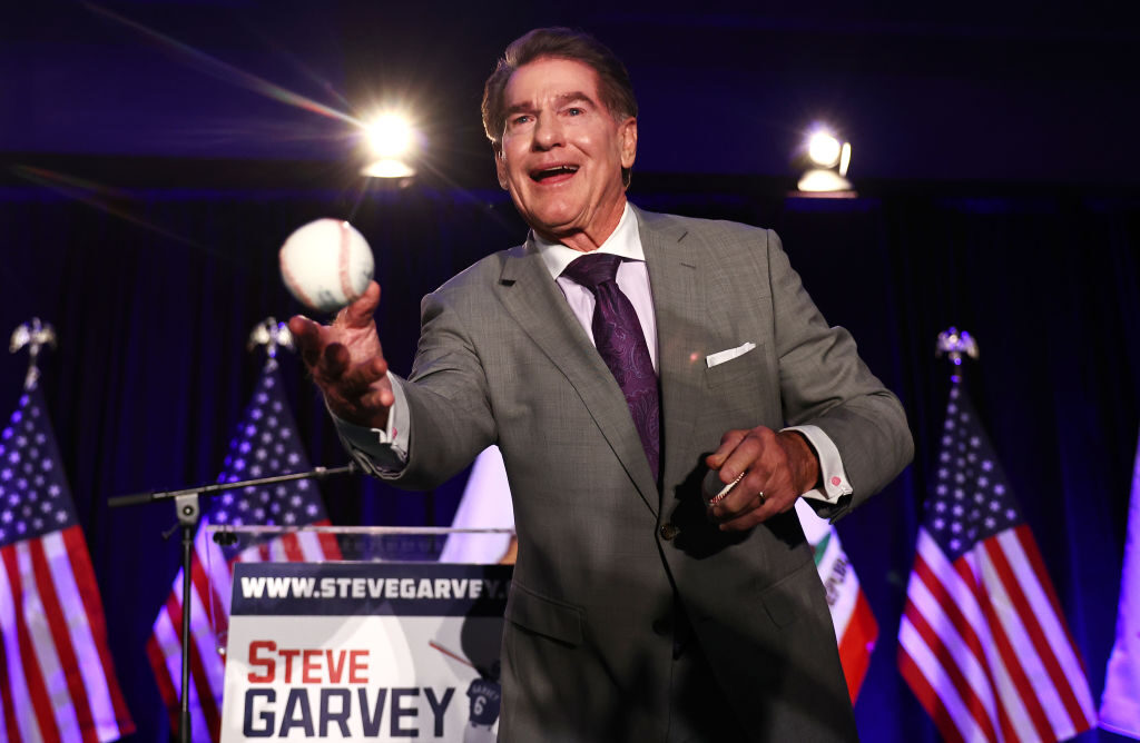 Republican Senate candidate Steve Garvey tosses a baseball to supporters at his election night watch party on March 5 in Palm Desert, Calif. 