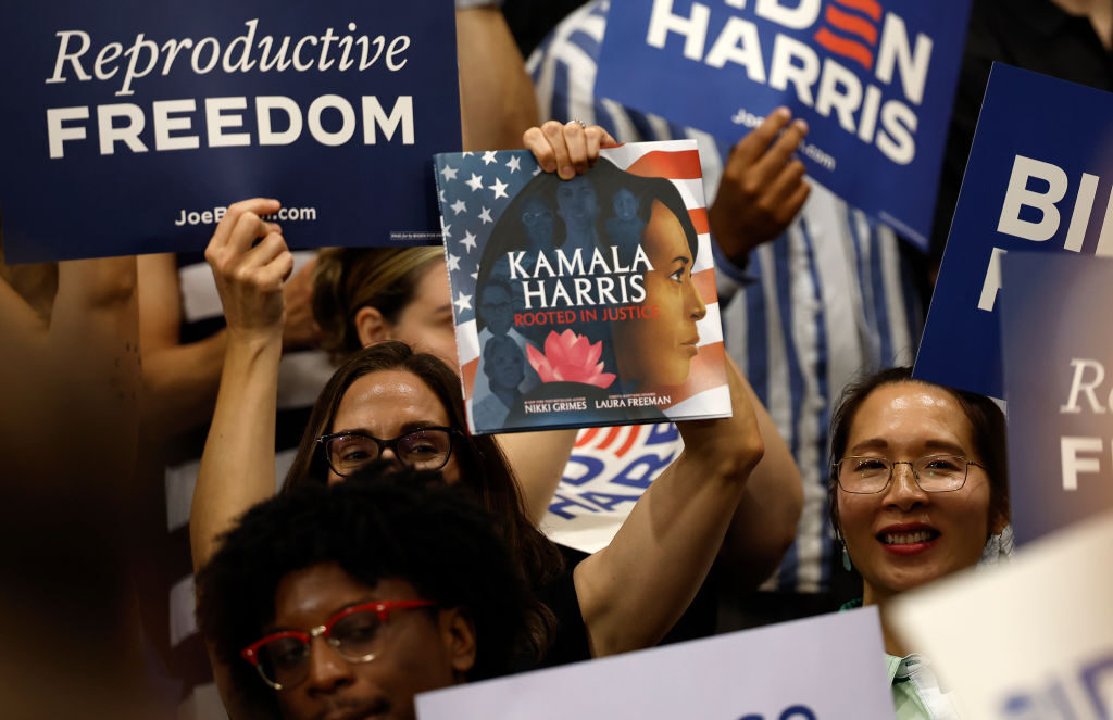 Supporters wave signs as Vice President Kamala Harris speaks at Ritchie Coliseum on the campus of the University of Maryland in College Park on Monday, the second anniversary of the Supreme Court ruling that overturned Roe v. Wade.