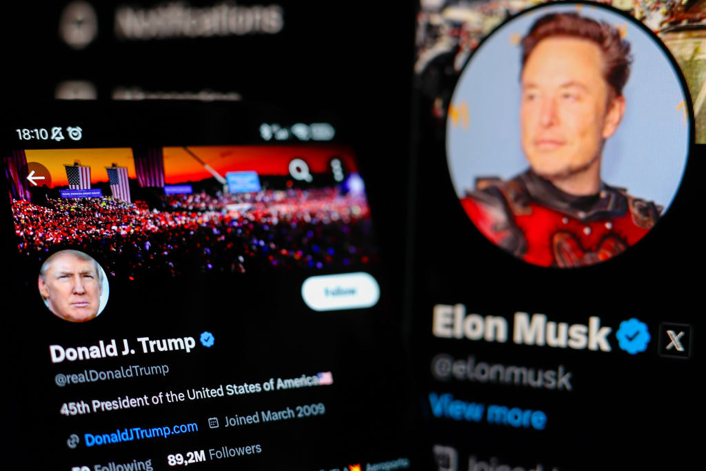 Former President Donald Trump's X (Twitter) profile is seen displayed on a smartphone, along with that of X owner Elon Musk, who hosted a conversation on that platform with Trump.