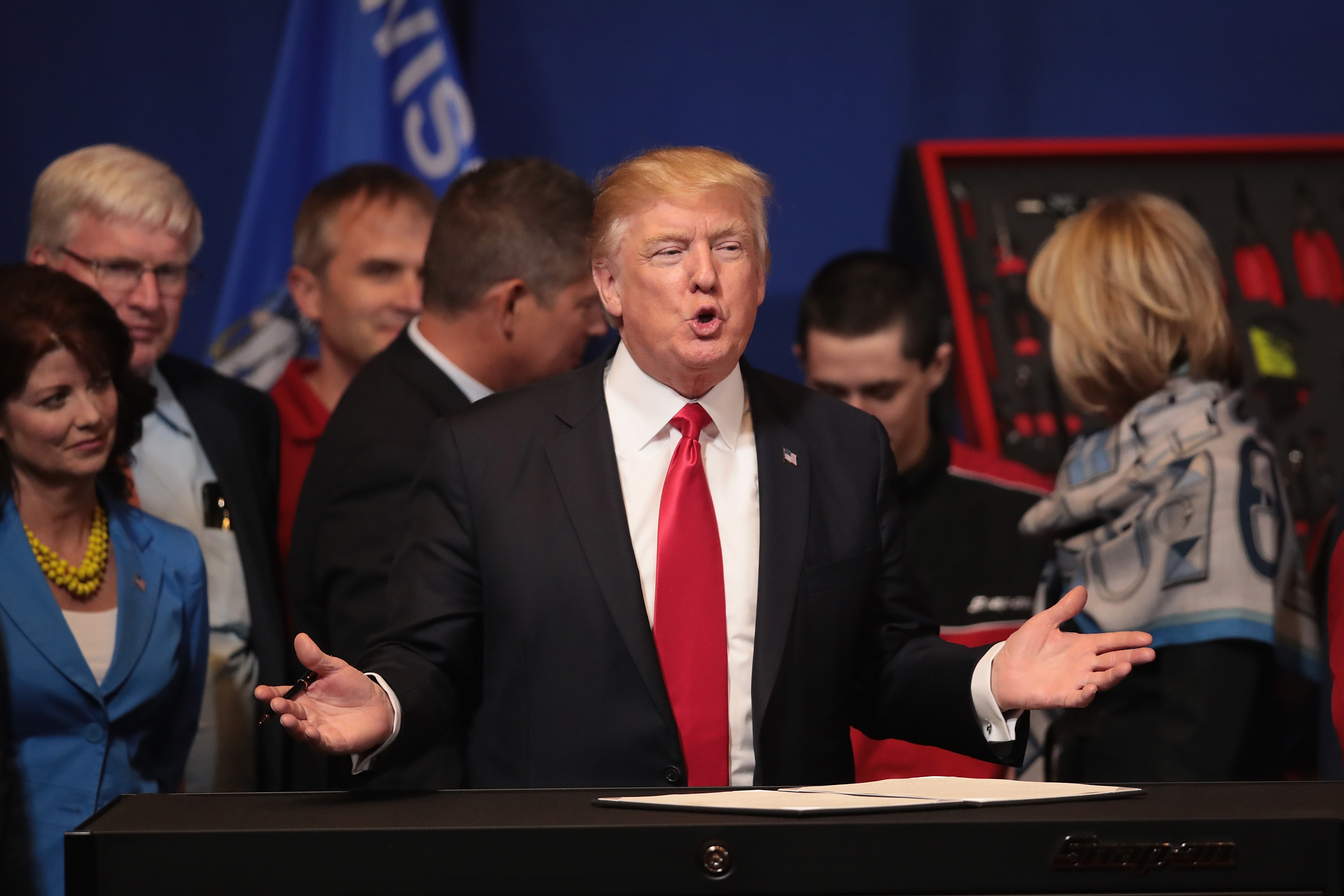 President Donald Trump prepares to sign an executive order last week in Wisconsin aimed at bringing jobs back to American. His 100th day in office is fast approaching without a legislative win. (Photo by Scott Olson/Getty Images)