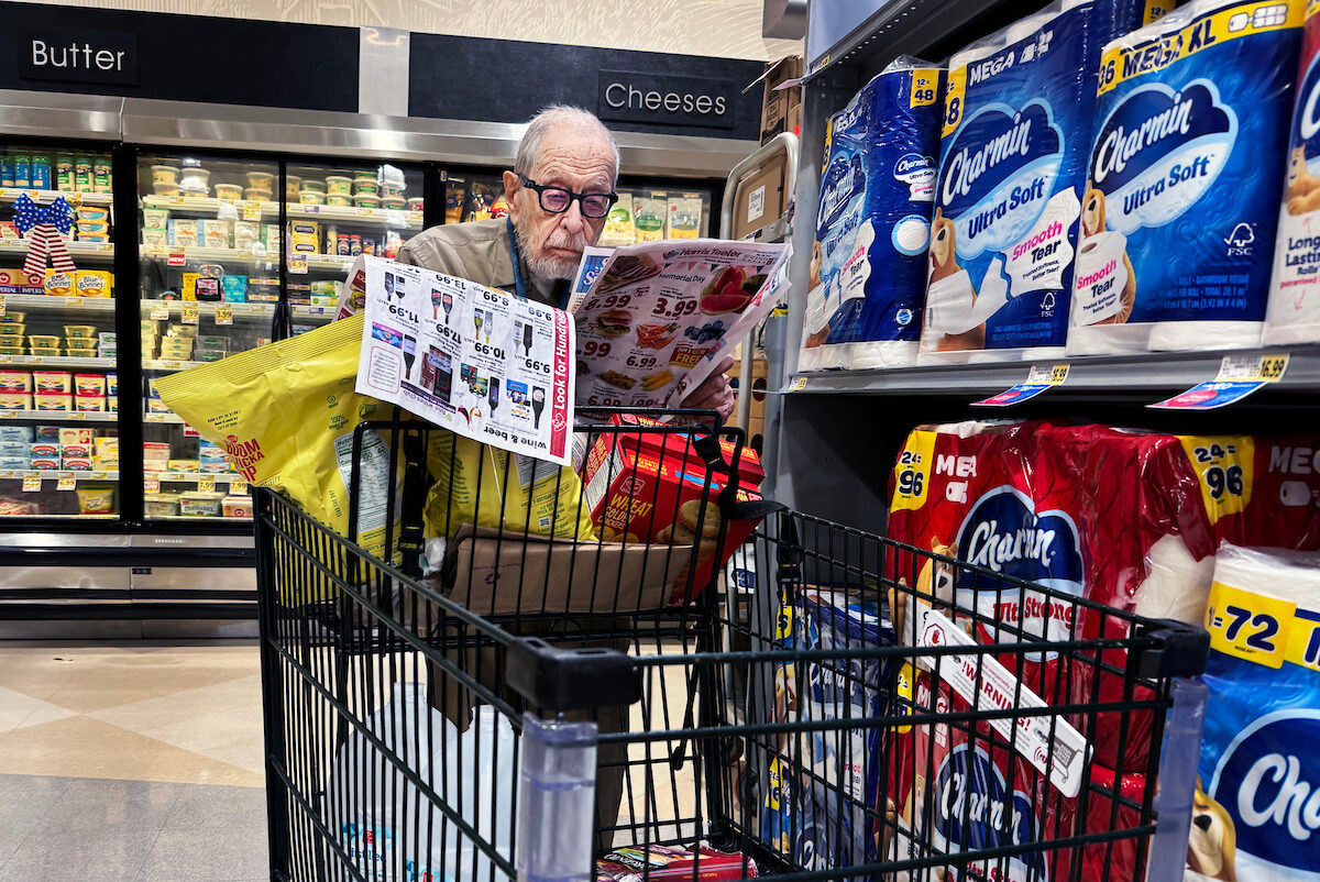 A shopper scans coupons in a grocery store in Washington, D.C., on May 23, 2024.