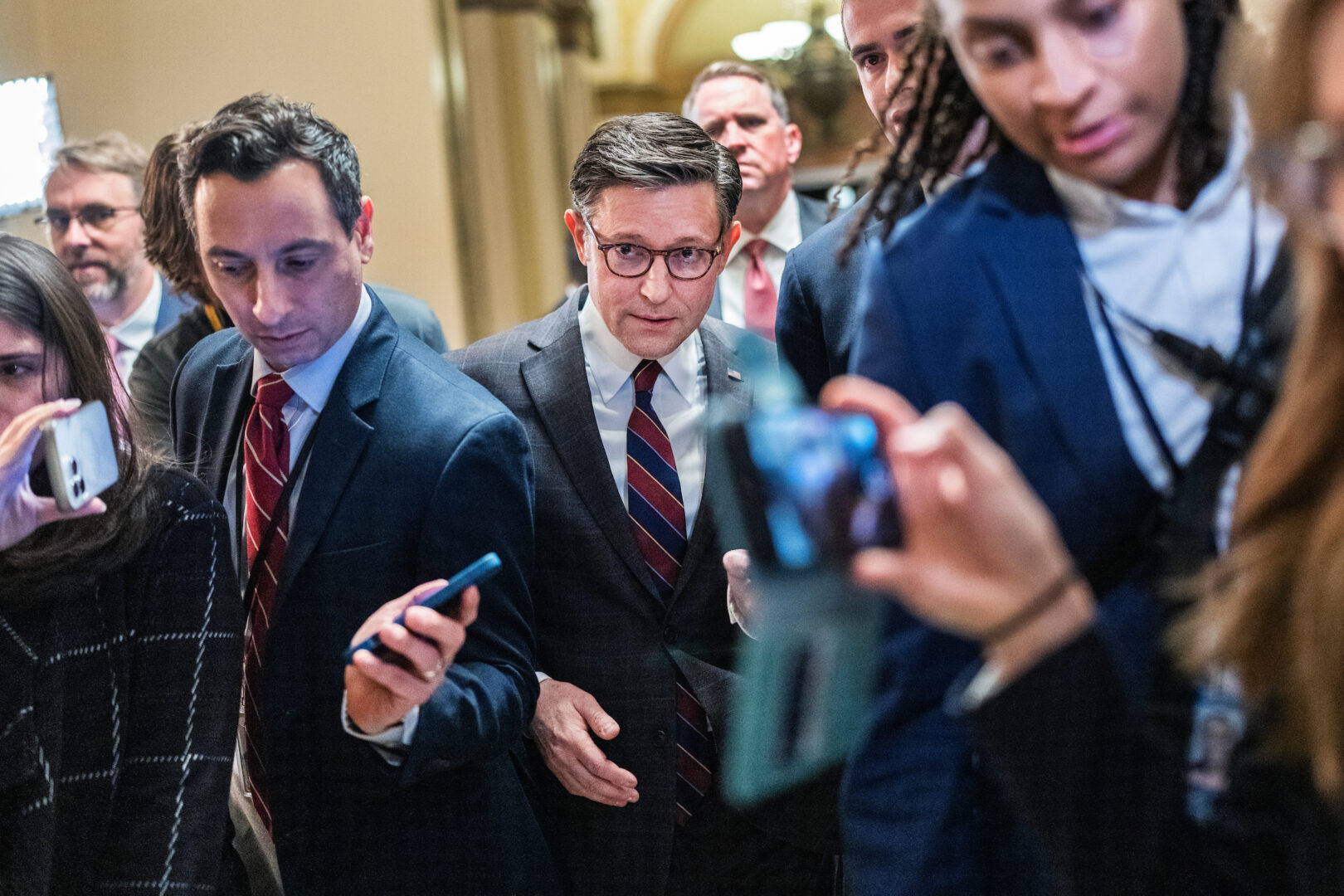 Speaker Mike Johnson, R-La., navigates through reporters in the Capitol on Thursday. 