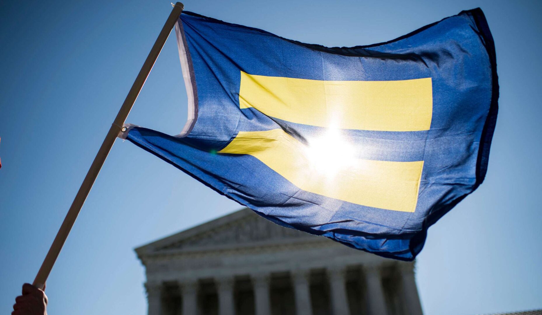 Gay marriage supporters wave equality flags outside the Supreme Court before the start of oral arguments on marriage equality in 2015.