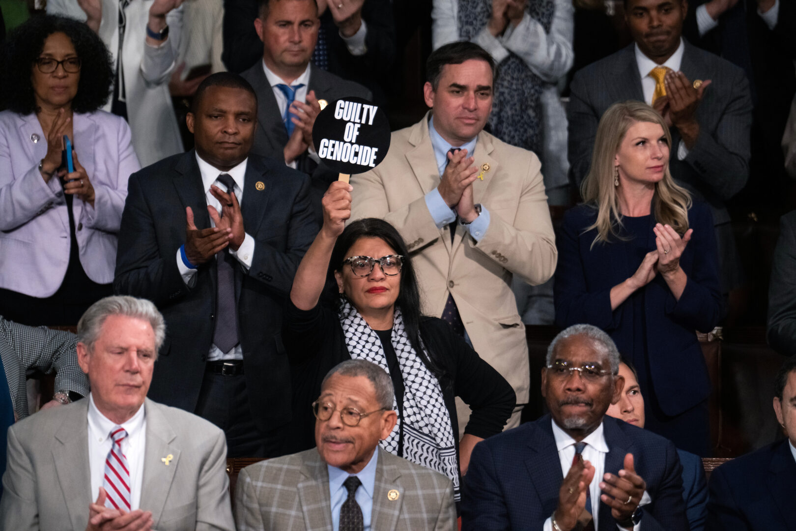 Rep. Rashida Tlaib, D-Mich., holds a “guilty of genocide,” sign as Israeli Prime Minister Benjamin Netanyahu addresses Congress on Wednesday. Outside, thousands were protesting the speech, including some Hill staffers. 