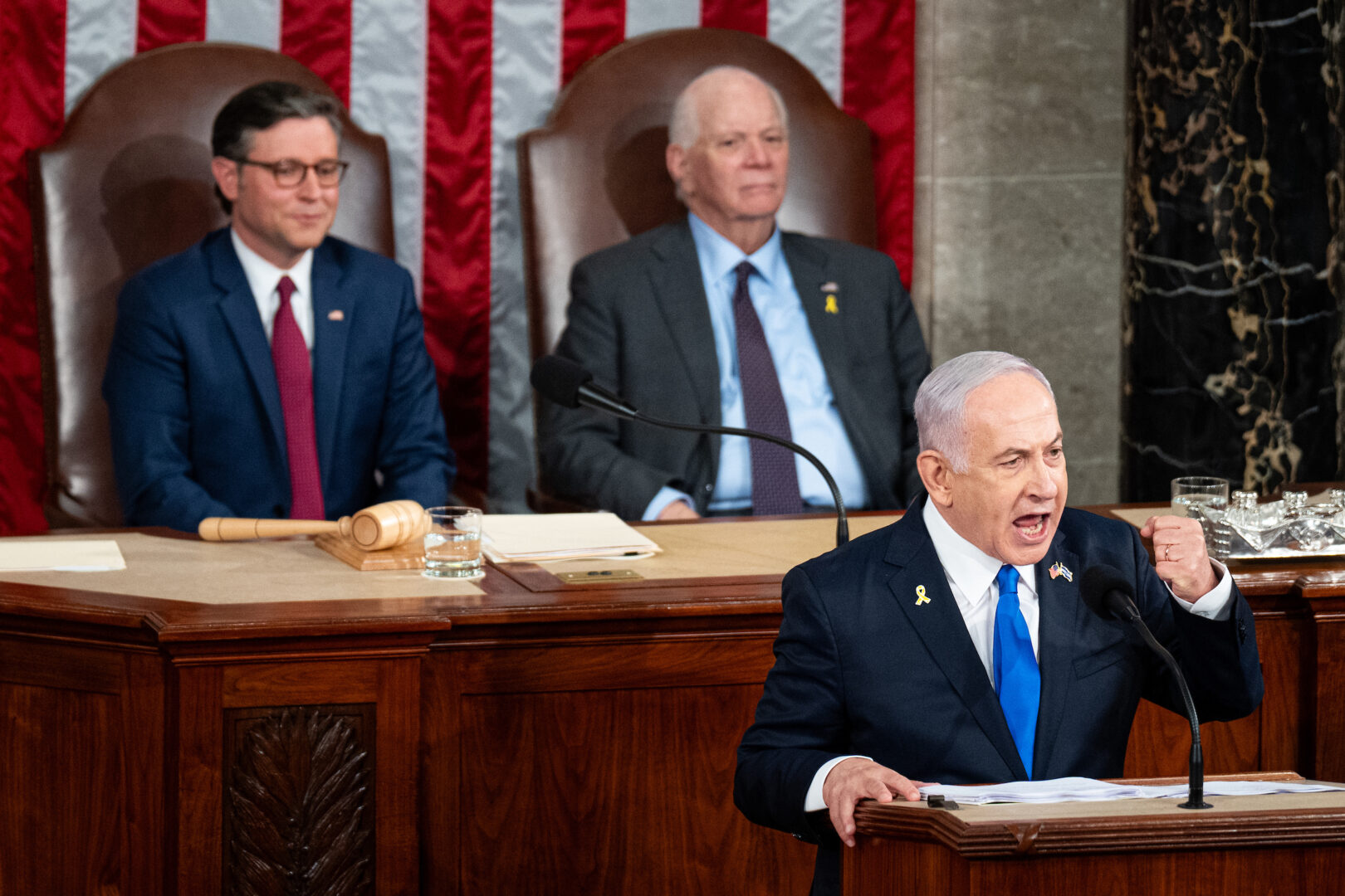 Israeli Prime Minister Benjamin Netanyahu speaks Wednesday to a joint meeting of Congress in the Capitol. In the back are Speaker Mike Johnson, R-La., and Sen. Ben Cardin, D-Md. 