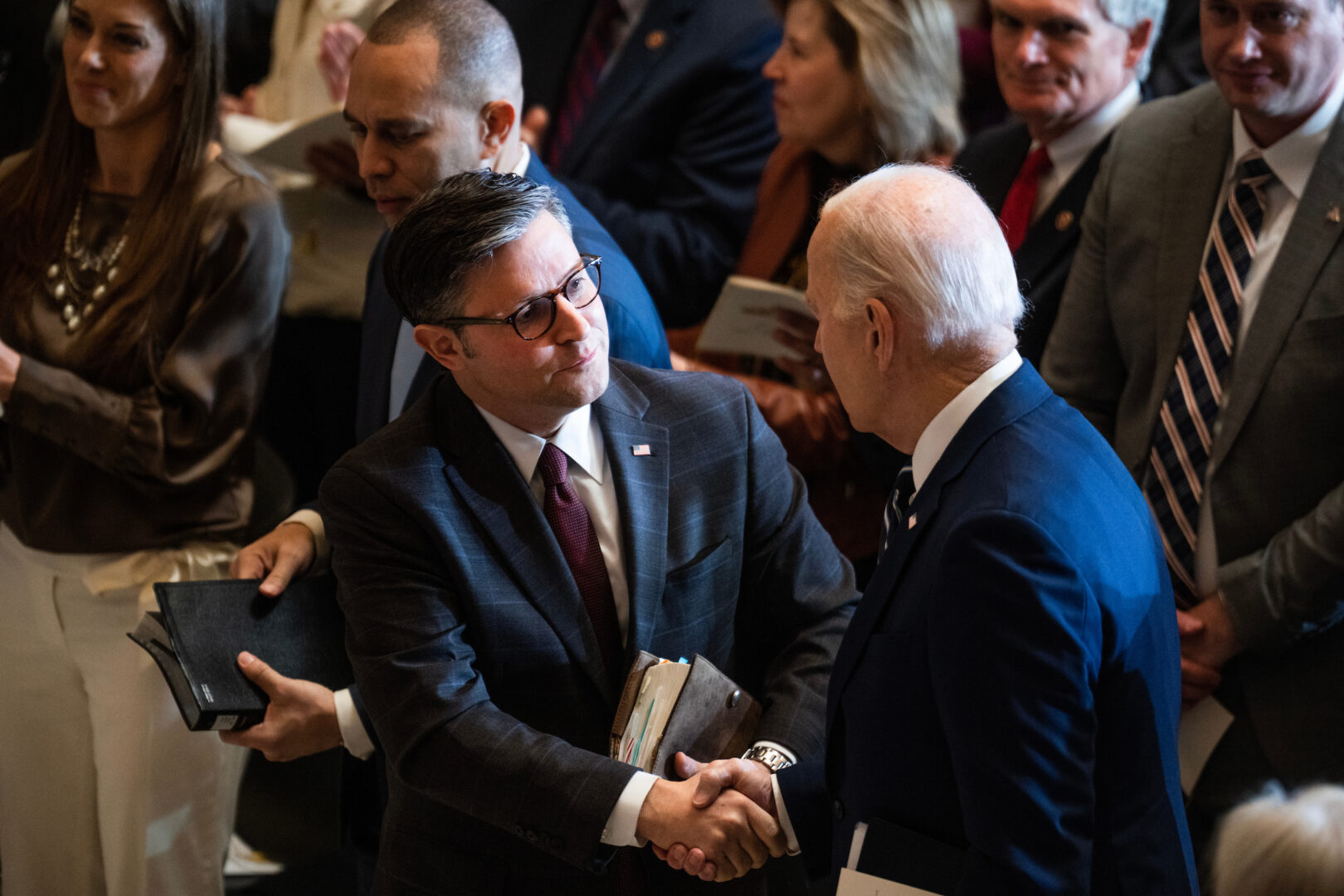 President Joe Biden, right, and Speaker Mike Johnson, R-La., shake hands after the National Prayer Breakfast in the Capitol’s Statuary Hall on Thursday. 