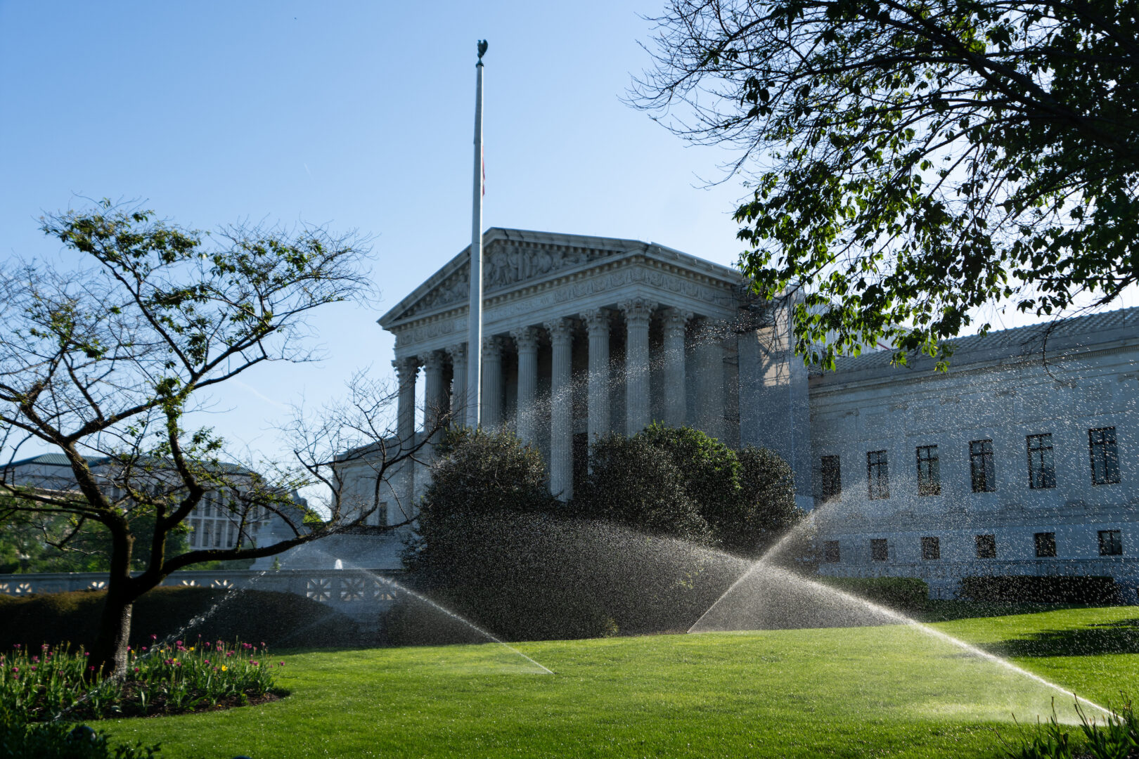 Sprinklers water the lawn in front of the Supreme Court in April. 