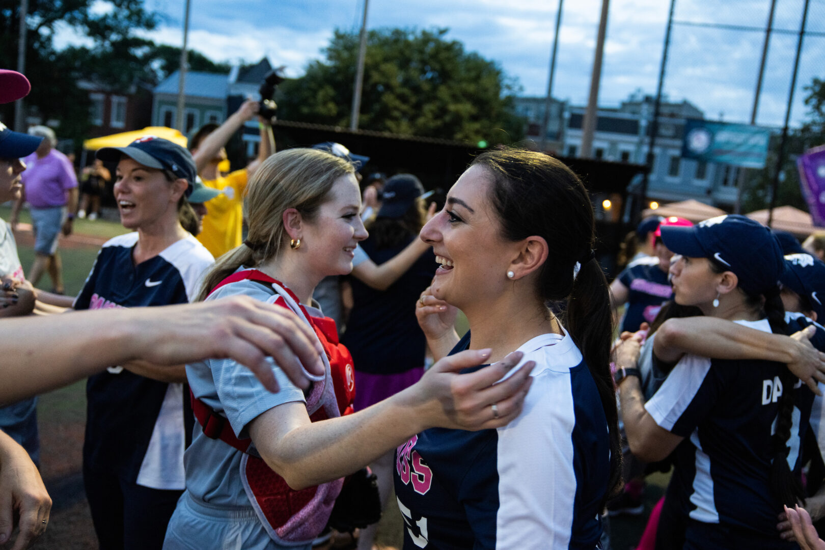 Rep. Sara Jacobs, D-Calif., right, congratulates Cassie Semyon of Spectrum News DC after the Congressional Women's Softball Game on Wednesday night.