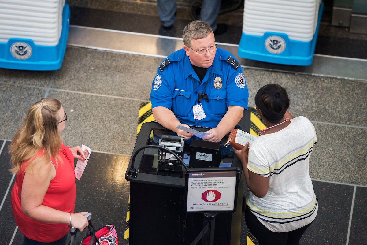 A Transportation Security Administration agent checks in passengers at Ronald Reagan Washington National Airport. (Tom Williams/CQ Roll Call)