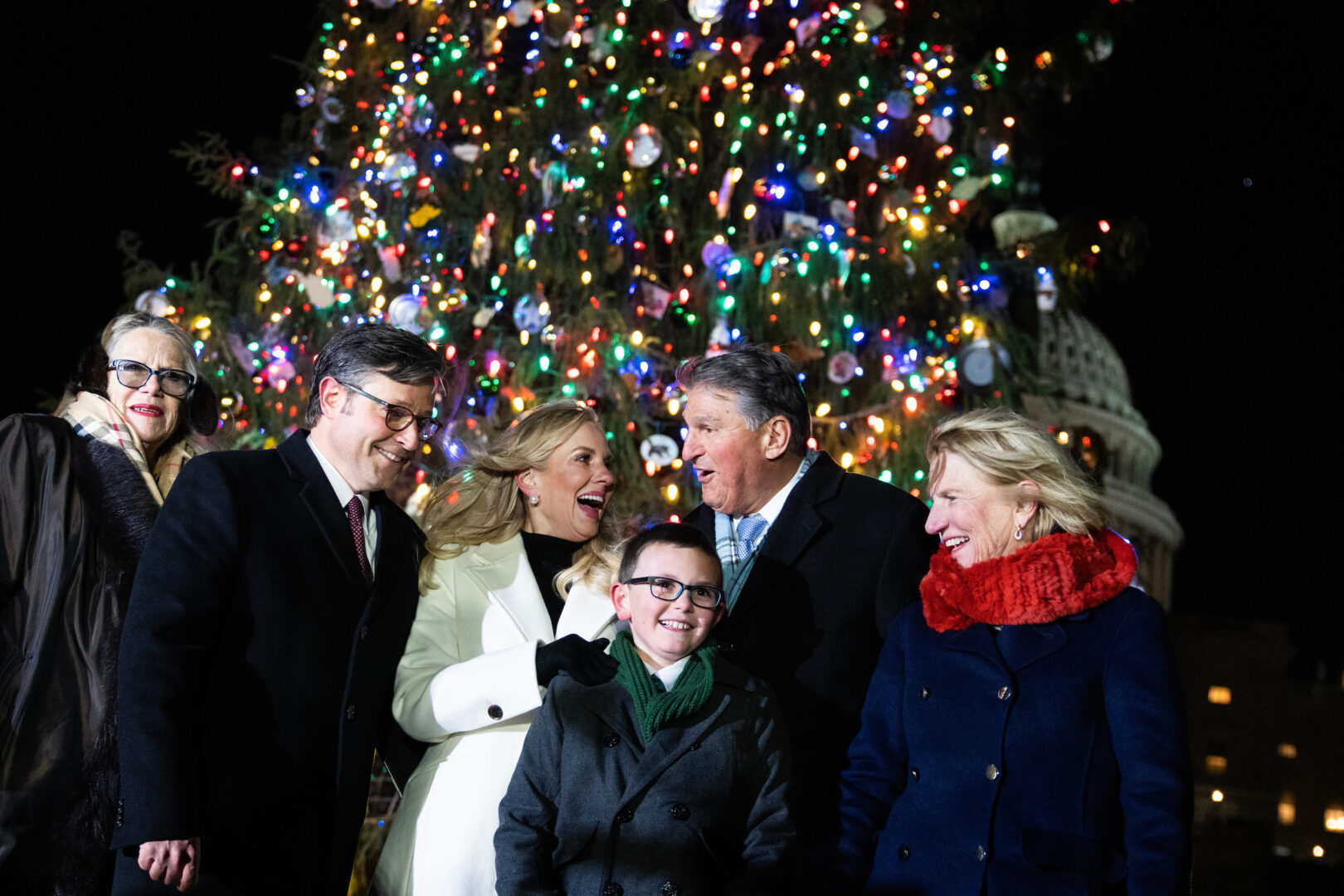 Speaker Mike Johnson and his wife, Kelly, pose with West Virginia lawmakers and fourth grader Ethan Reese in front of the Capitol Christmas Tree on Tuesday.