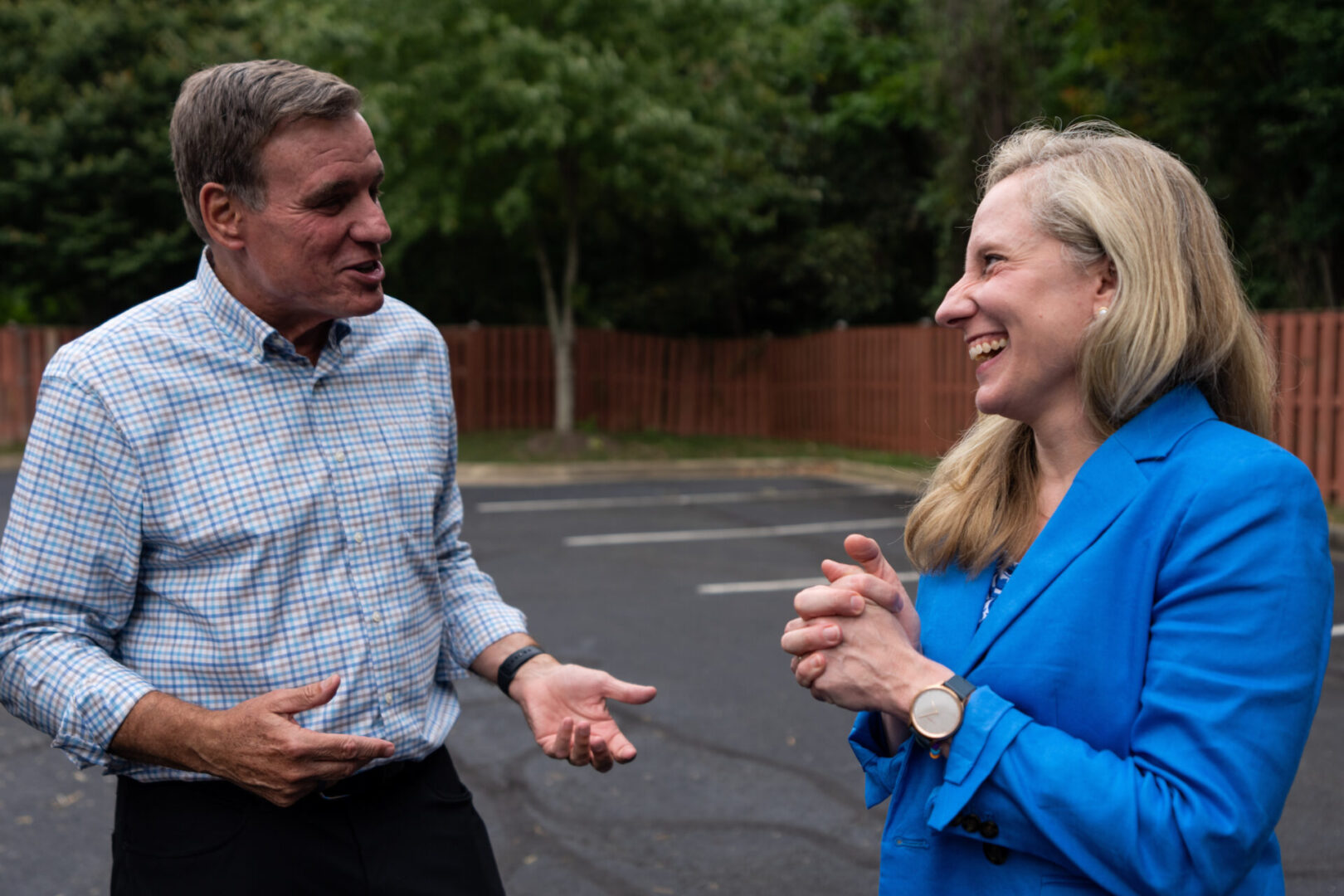 Rep. Abigail Spanberger, right, and Sen. Mark Warner, both D-Va., meet with reporters following a Prince William County early voting rally for Spanberger in Woodbridge, Va., on Sept. 24. Spanberger won a competitive reelection race Tuesday.